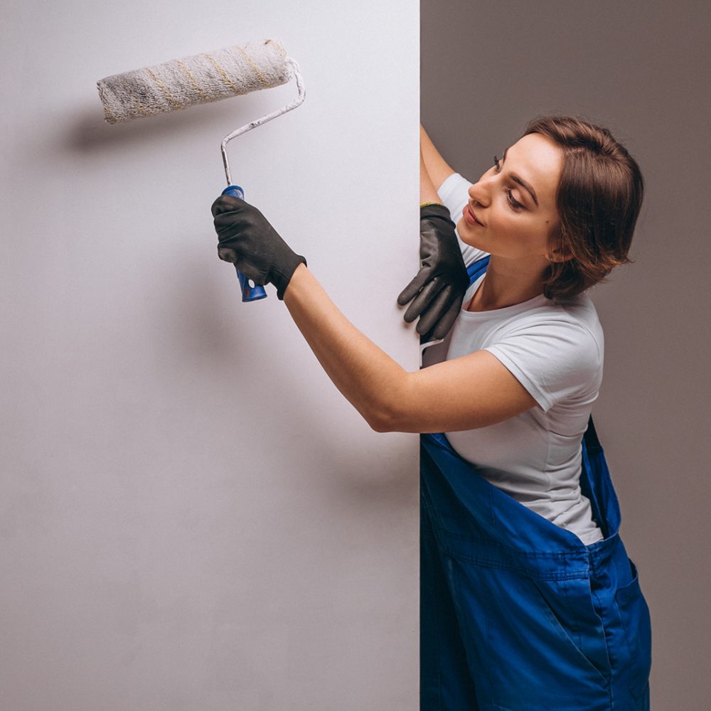 Woman repairer with painting roller isolated