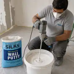 Professional worker mixing Silky Wall Putty using a low-speed paddle mixer.