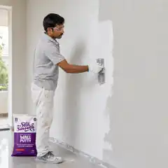 Professional worker smoothing the second coat of Silky Wall Putty with a finishing trowel.